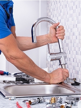 Man repairing a kitchen faucet