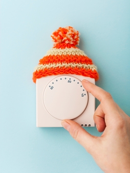 Wall thermostat for heating adjustment with a colored wool cap