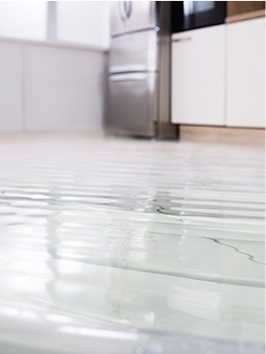 Tiled floor of a kitchen flooded with water